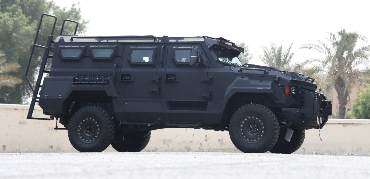 2025 MERKAVA SAGIV 79 4X4 AT BR6 armored vehicle with assault ladder, ballistic glass, and all-terrain tires against palm backdrop