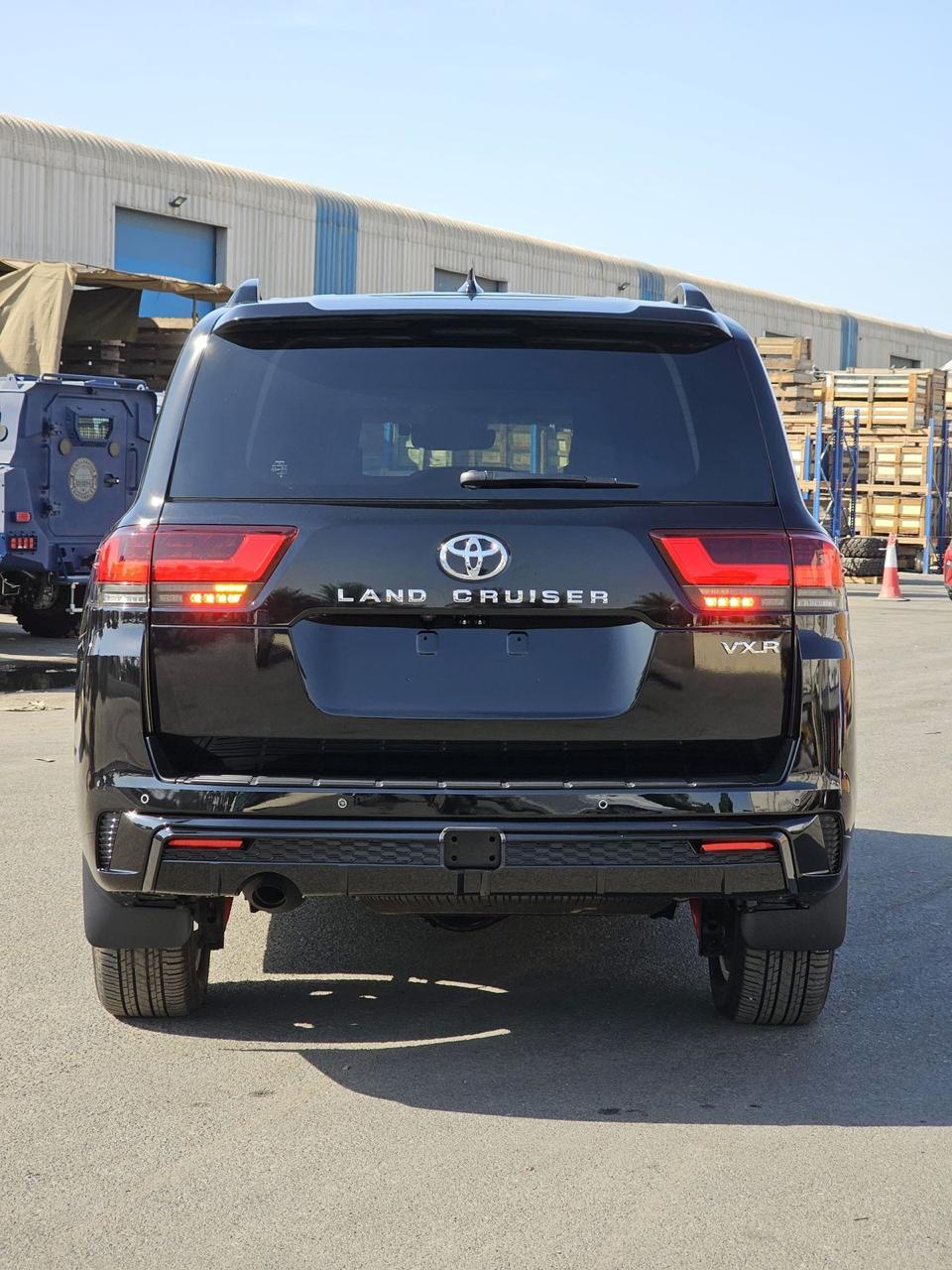 2025 Toyota Land Cruiser 300 VXR rear view with LED taillights, VXR badging and black finish