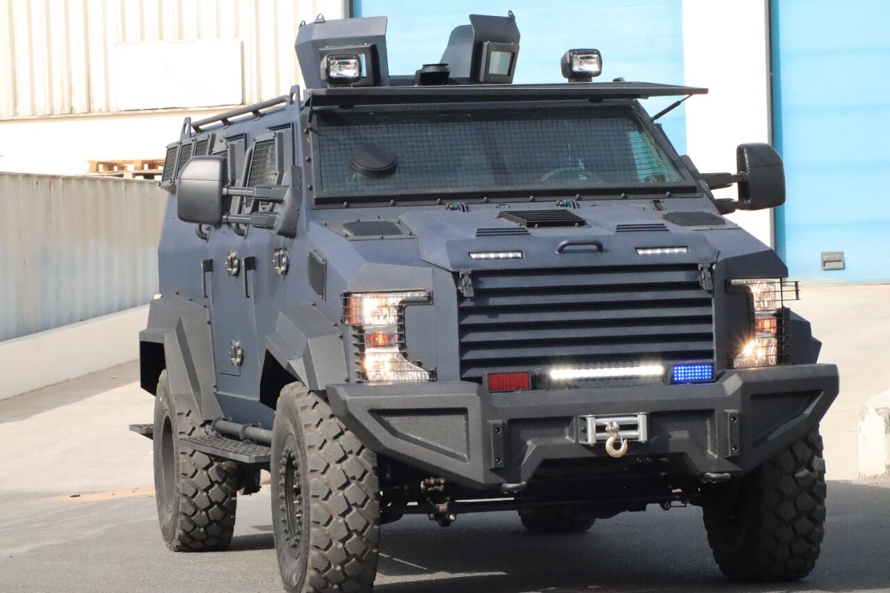 Ford F550 TAV APC front view with lights on and armored body