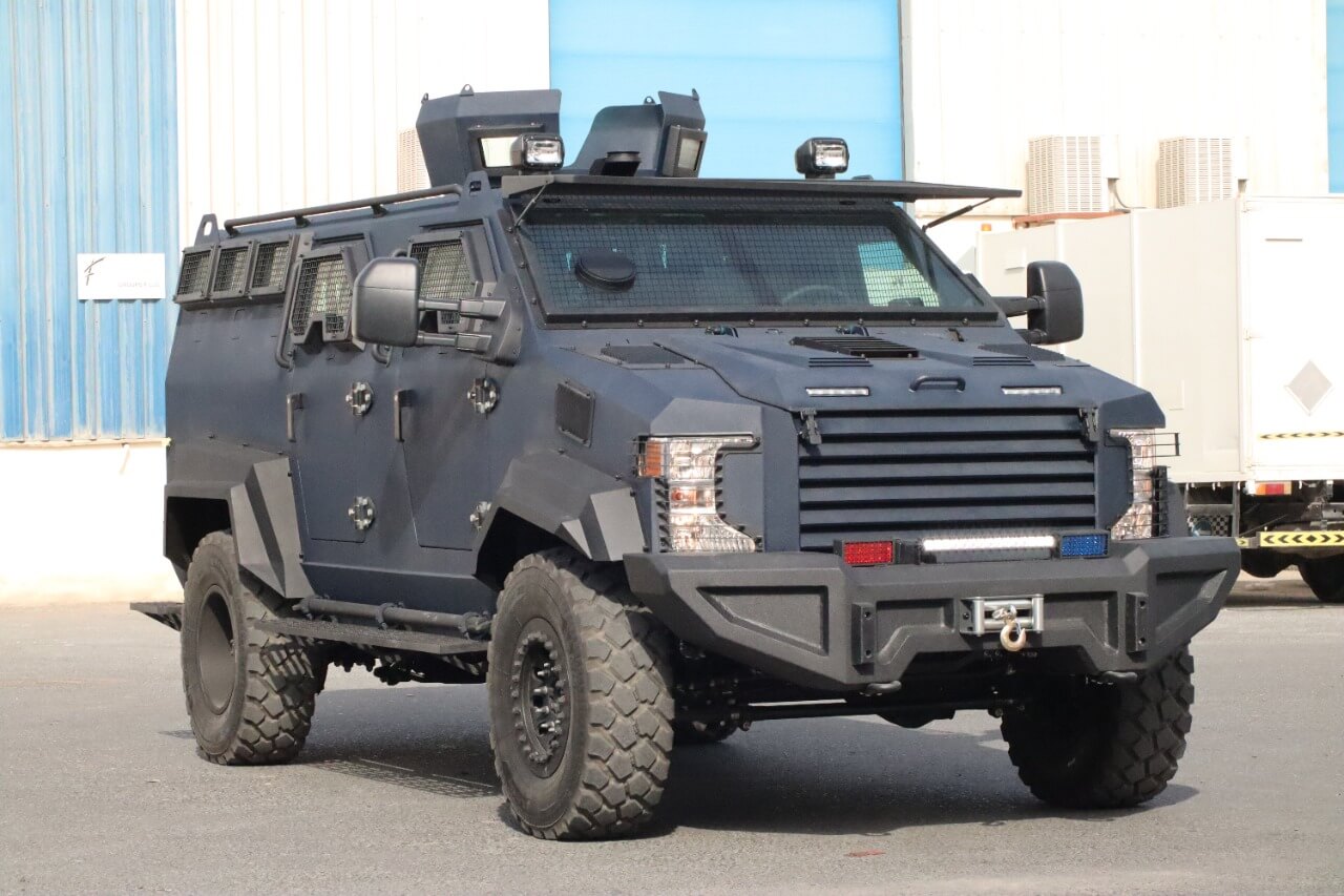 Ford F550 6.7 V8 armored personnel carrier by SchutzCarr, tactical assault vehicle with heavy-duty protection, front right angle view showing reinforced chassis and bulletproof exterior