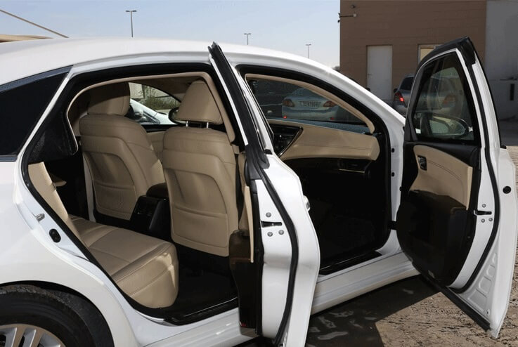 Armored Toyota Avalon sedan with doors open exterior view