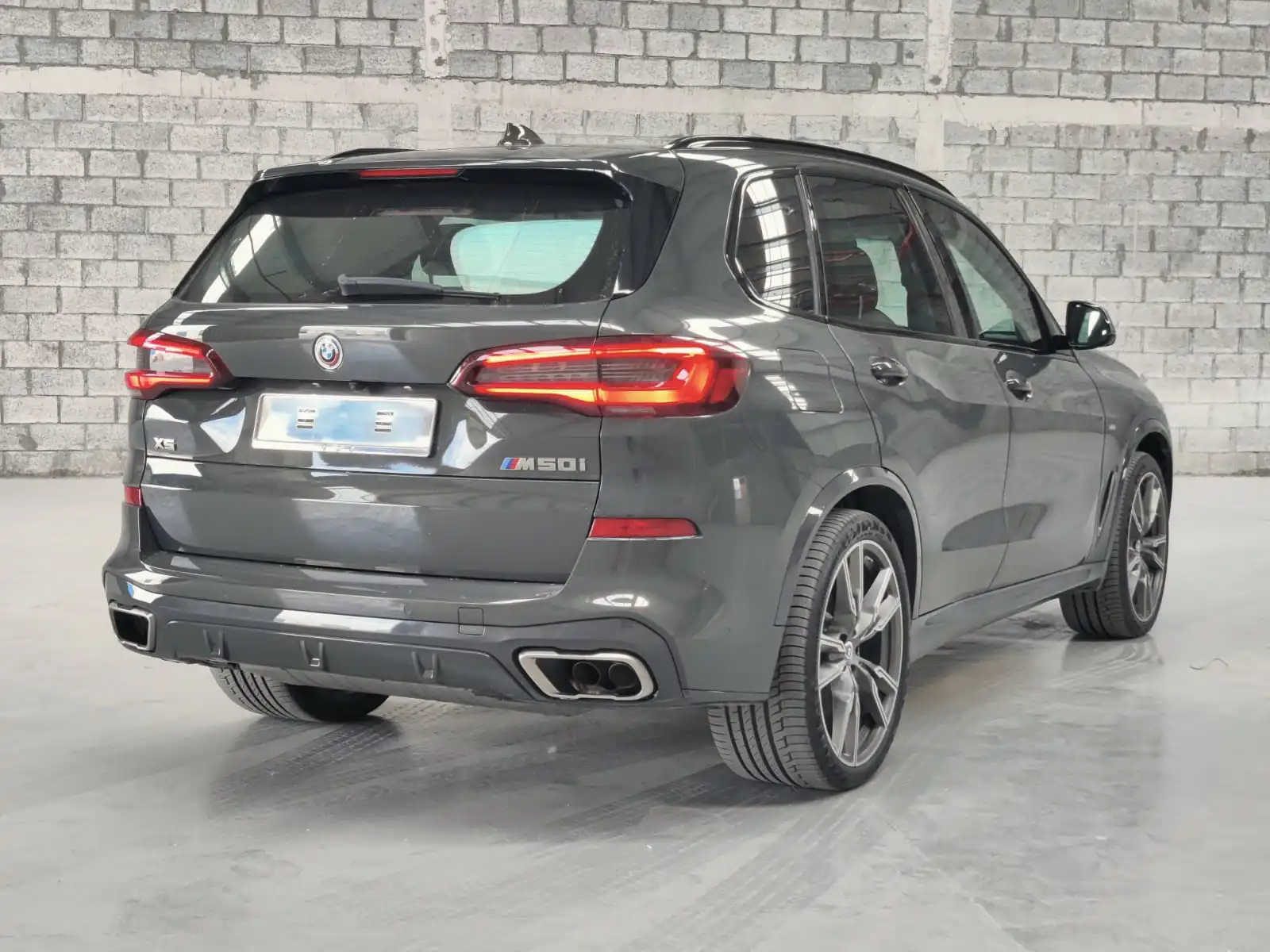 BMW X5 M50i grey armored luxury SUV rear right exterior angle