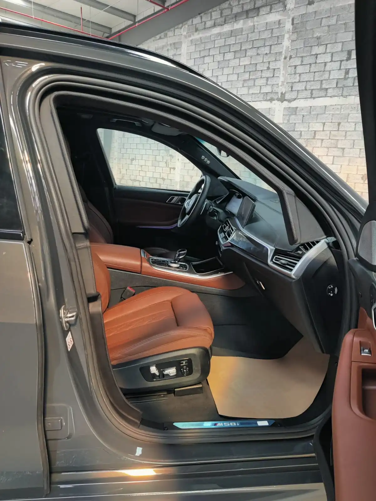 BMW X5 M50i grey armored luxury SUV passenger door open view