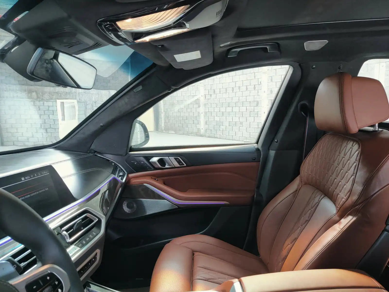 BMW X5 M50i grey armored luxury SUV passenger seat detail