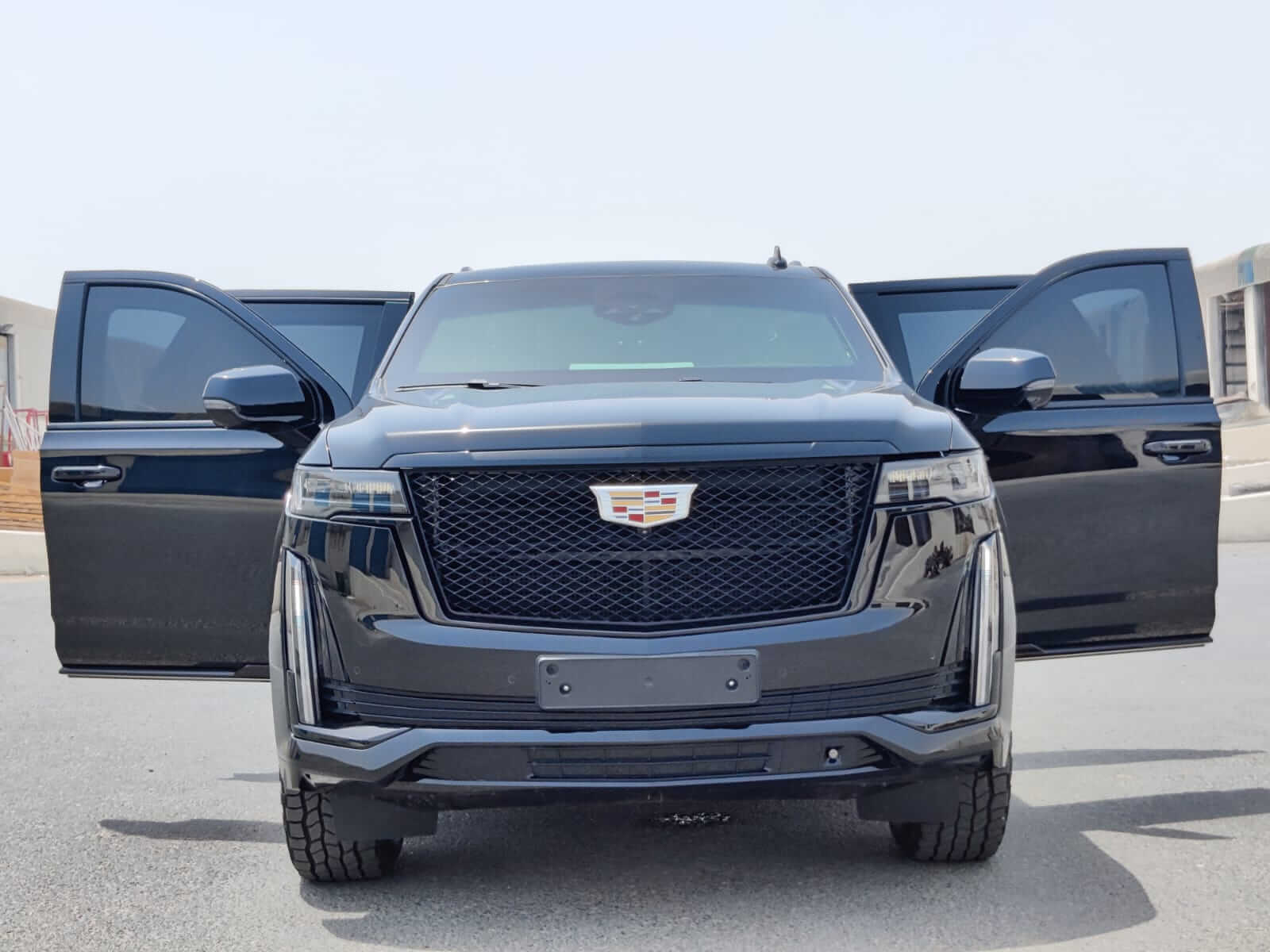 Cadillac Escalade armored luxury SUV front view with doors open