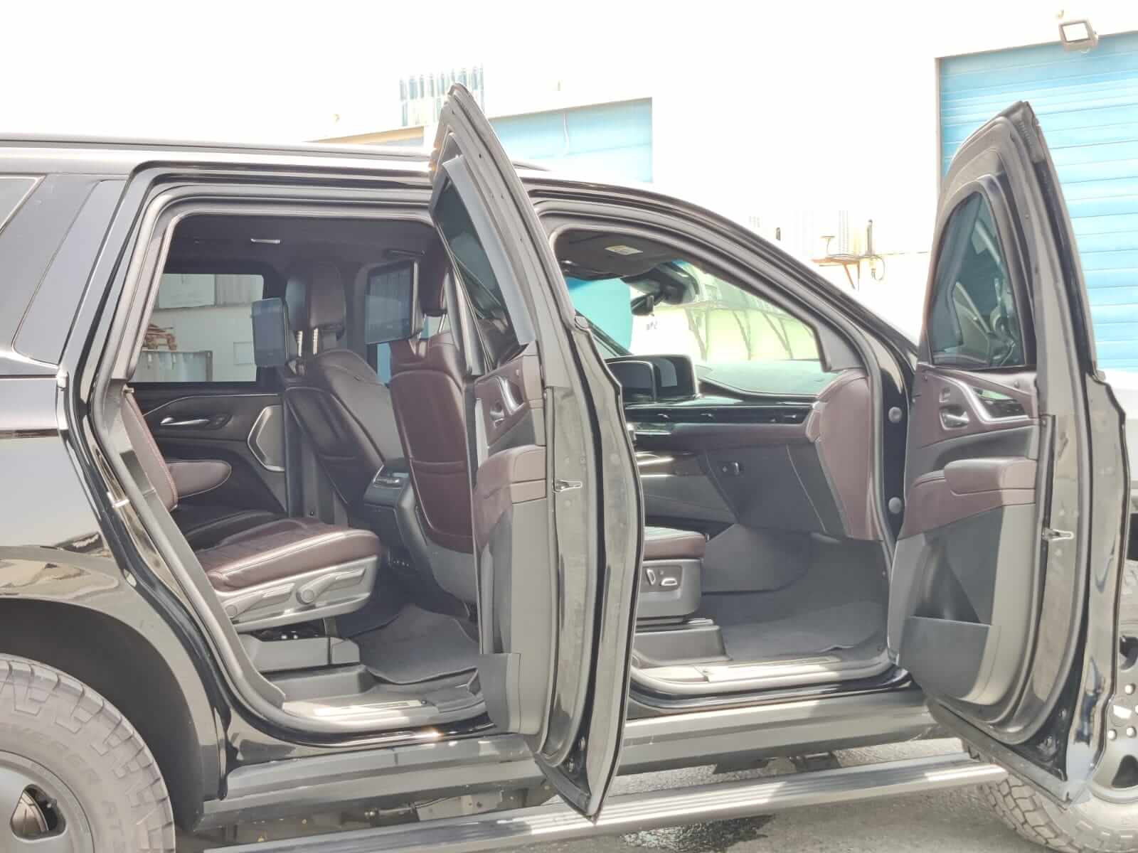 Cadillac Escalade armored luxury SUV right side with doors open