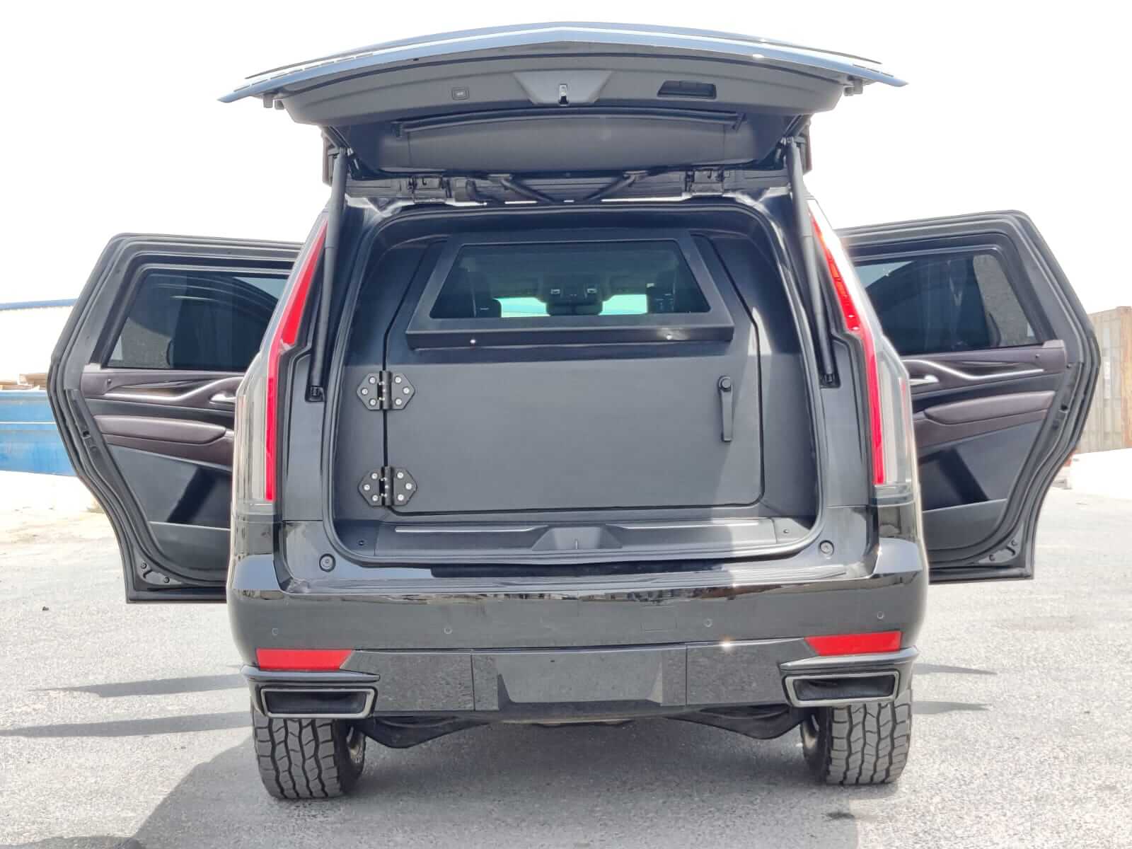 Cadillac Escalade armored luxury SUV trunk and doors open view