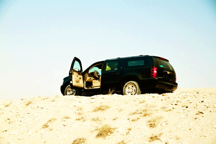 Chevrolet Suburban with Driver's Door Open.
