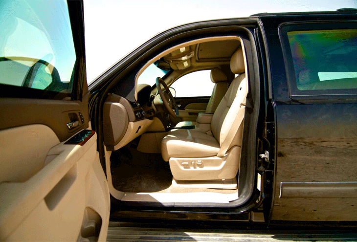 Chevrolet Suburban: Open Driver's Door Reveals Spacious Interior.