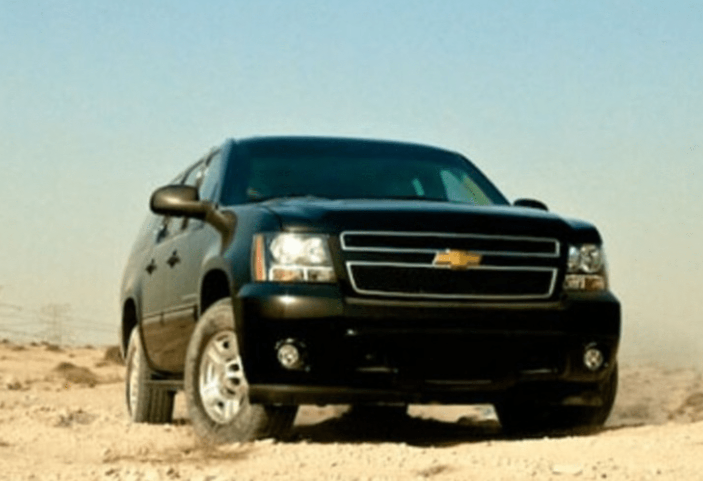 Chevrolet Suburban Front View: A sleek, powerful SUV stands tall against a scenic backdrop, embodying strength and sophistication.