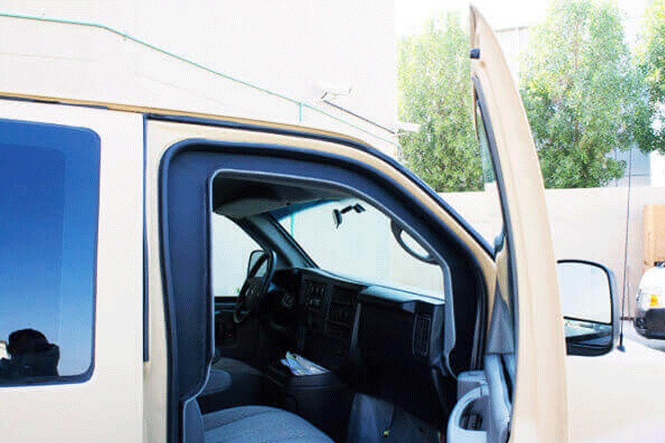GMC Savana passenger door open showing protected cabin access