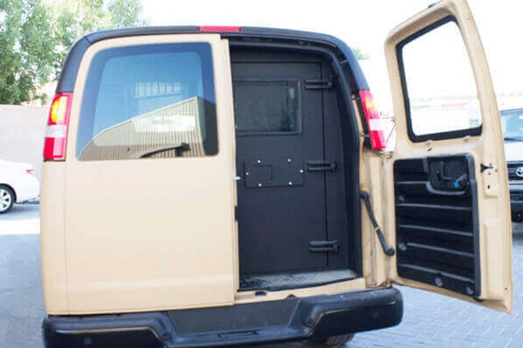 GMC Savana trunk open showing rear access for passenger carrier