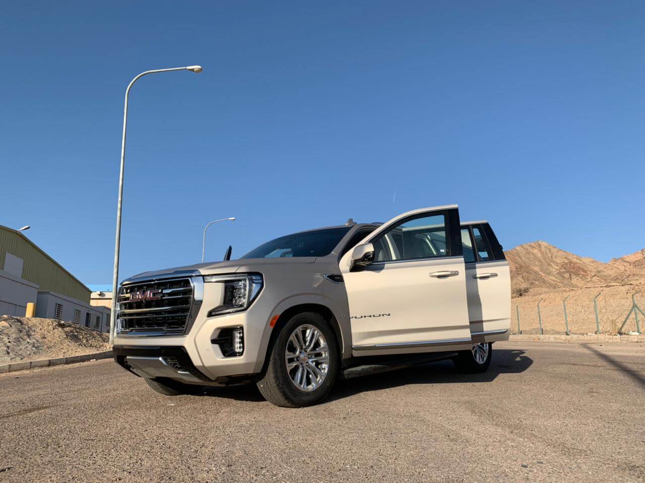 GMC Yukon side view with doors open for cabin inspection