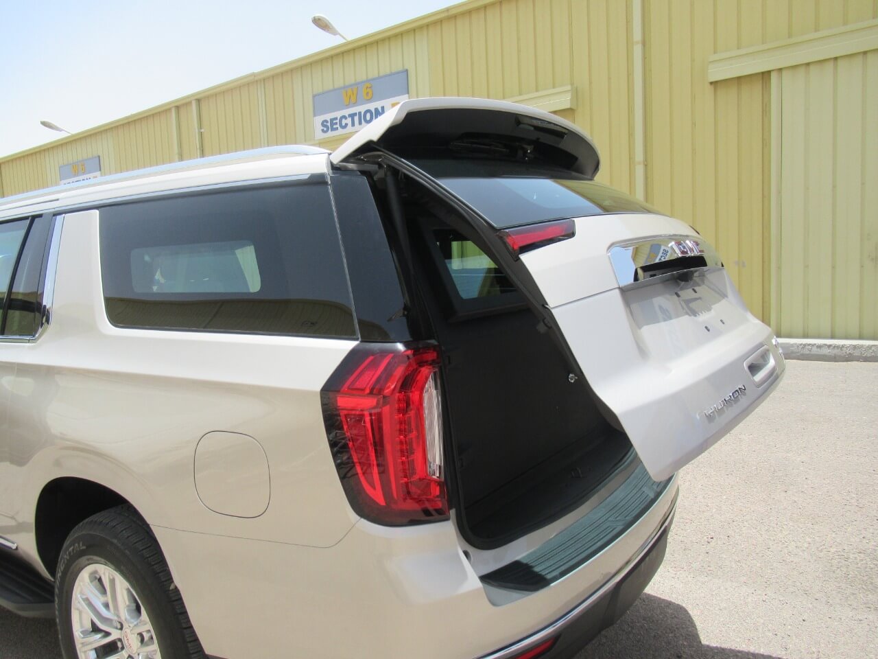 GMC Yukon trunk slightly open showing rear access