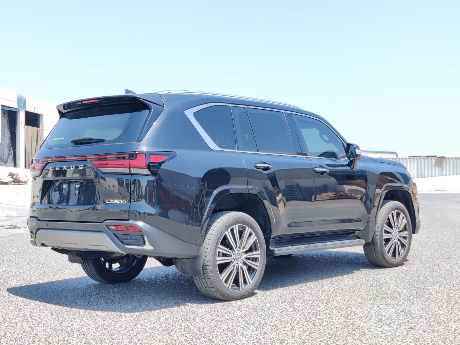 Lexus LX600 BR9 rear right view with luxury SUV tailgate and body lines