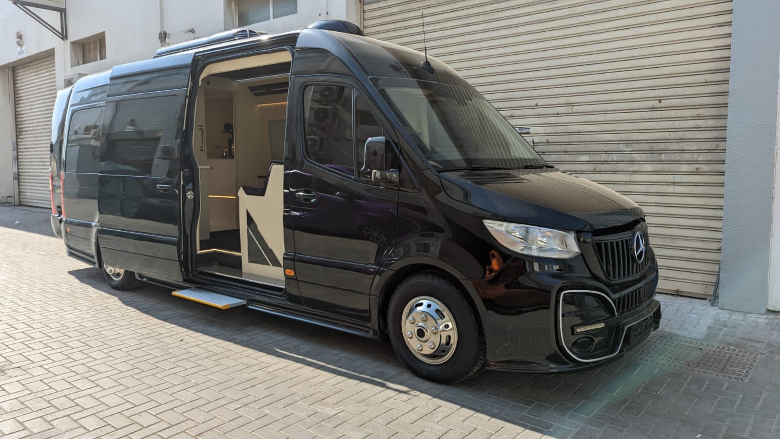 Armored Mercedes-Benz Sprinter VIP BR6 with open side door - luxury civilian personnel carrier with ballistic protection by SchutzCarr for secure transport