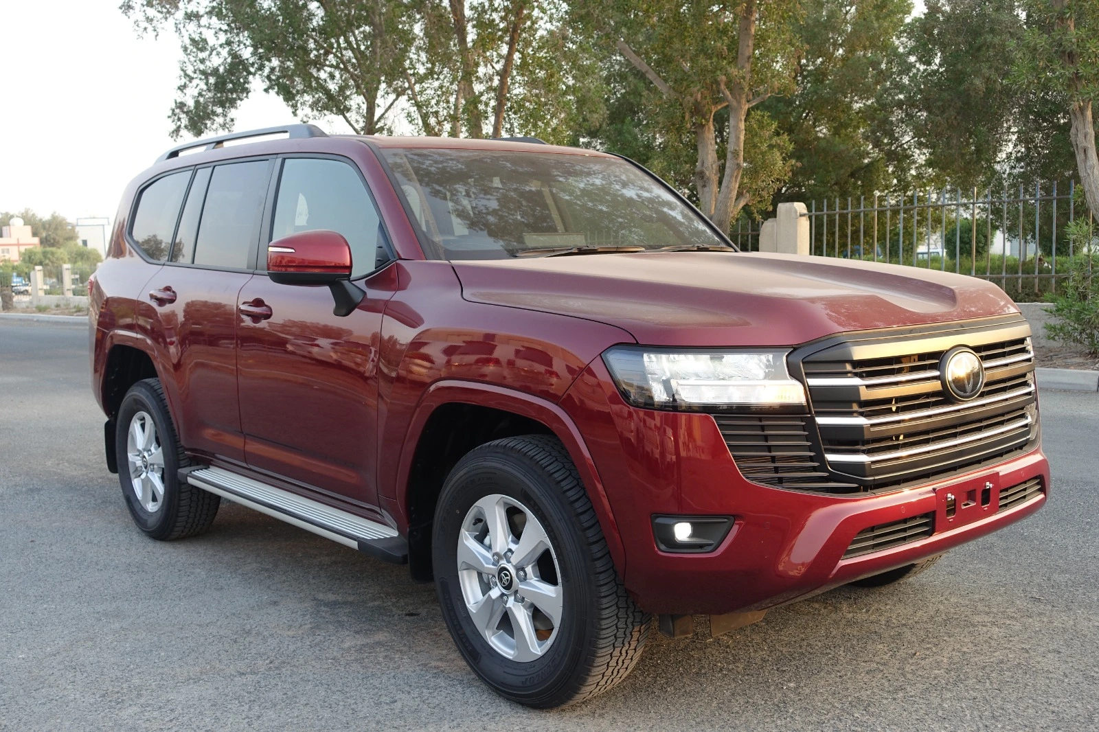 Toyota Land Cruiser 300 armored SUV in red, front-right angle view, luxury bulletproof vehicle with B6 protection for high-security transportation