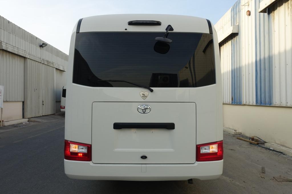 Toyota Coaster BR6 armored bus rear view with lights on