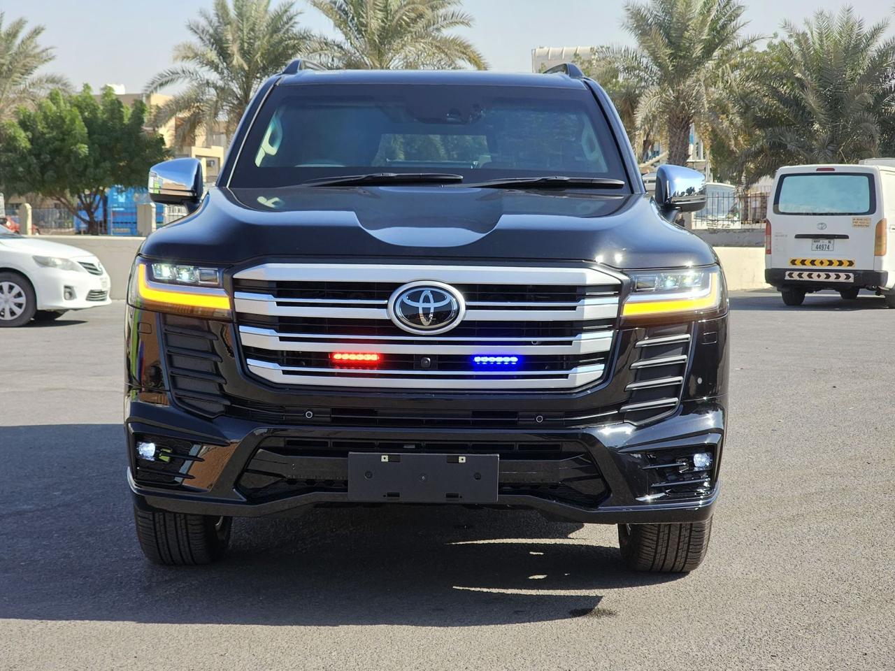 Toyota Land Cruiser 300 VXR front view with chrome grille, LED headlights and emergency lights